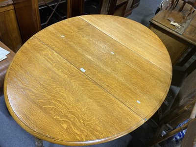 Lot 217 - Light oak gateleg dining table.