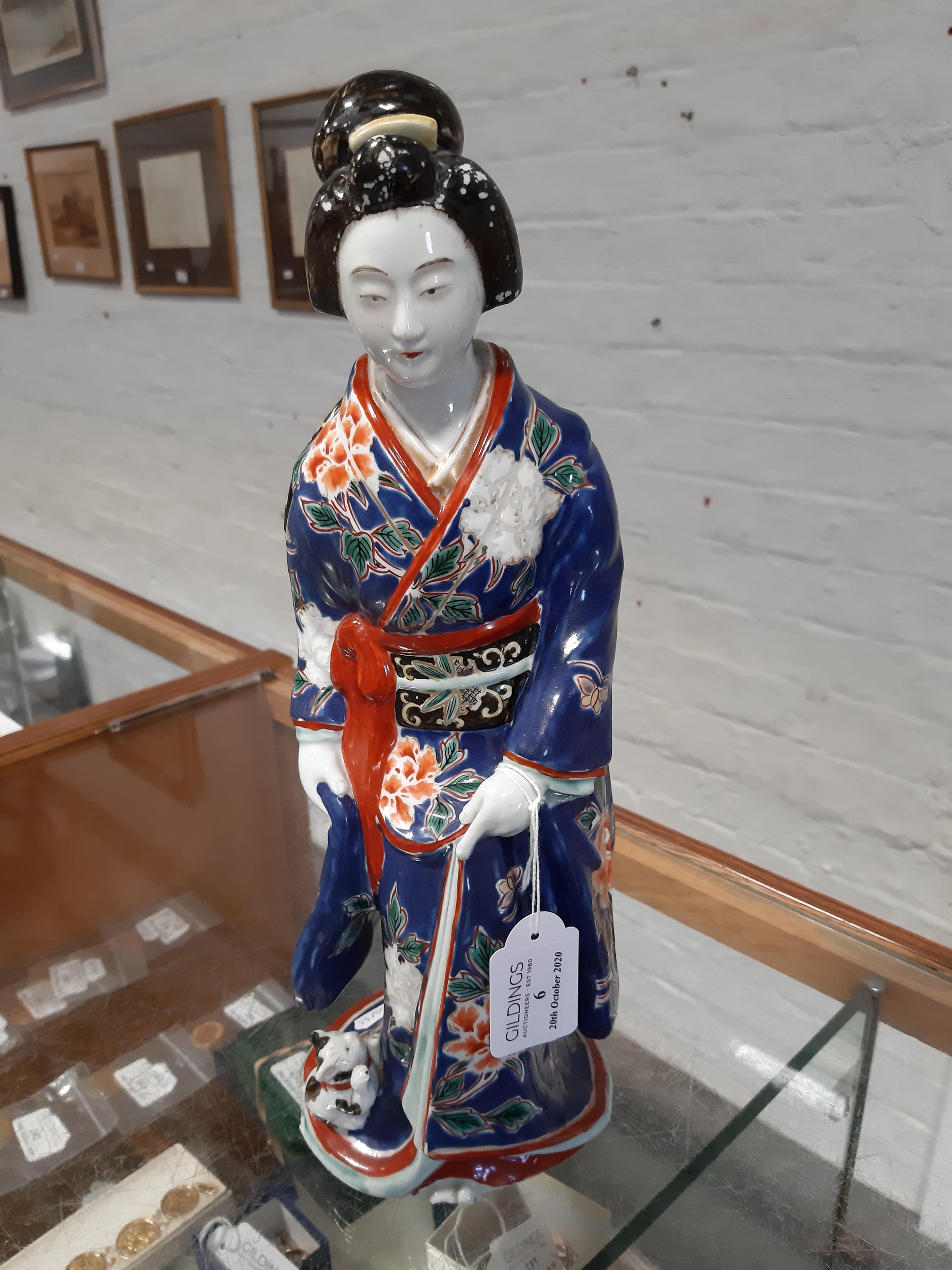 Lot 6 A Japanese porcelain Geisha figurine