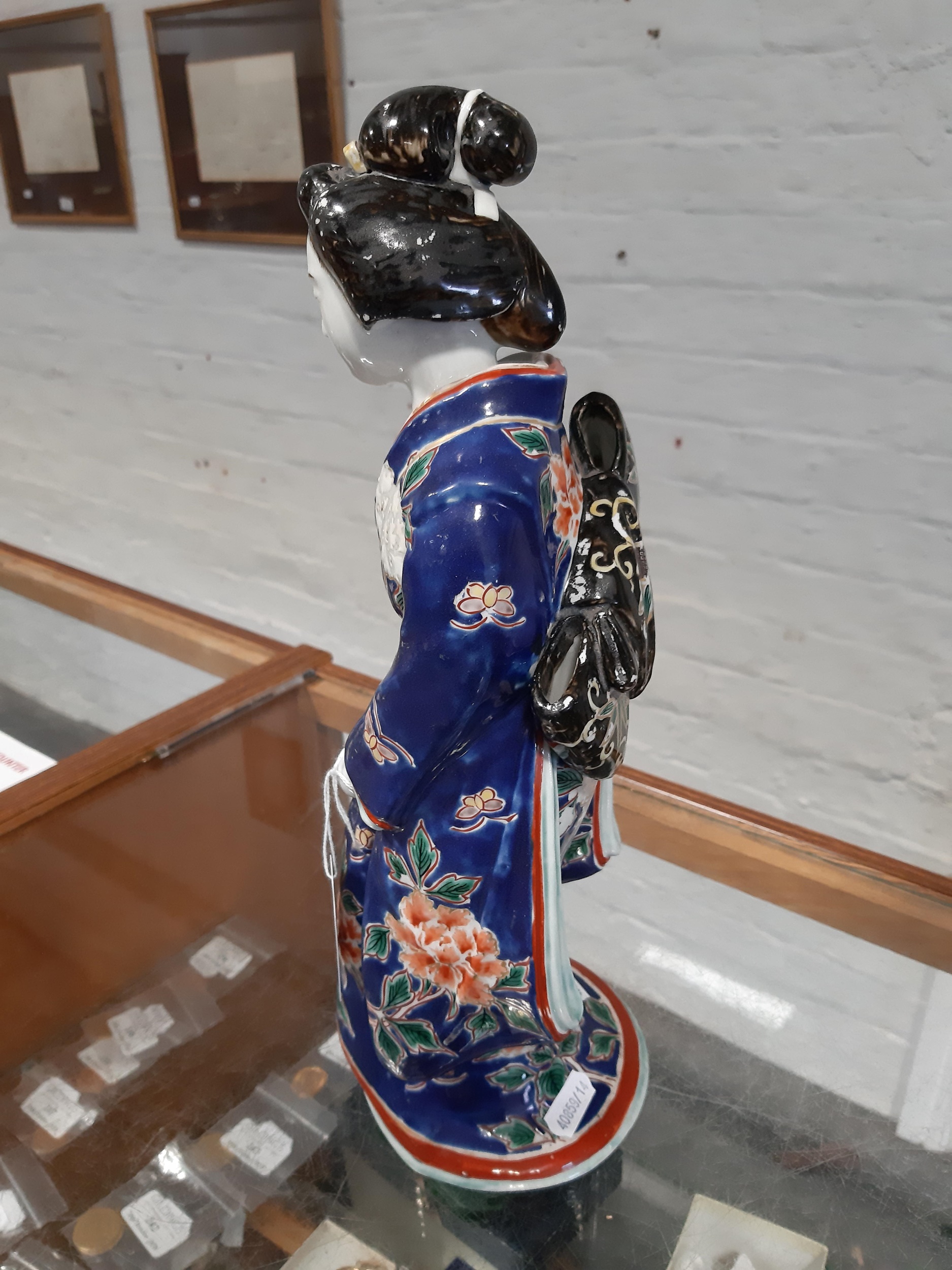Lot 6 A Japanese porcelain Geisha figurine