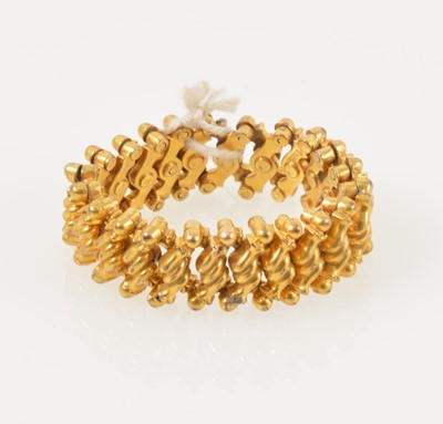 Lot 328 - A yellow metal expanding bracelet, 8mm wide, child’s small size.