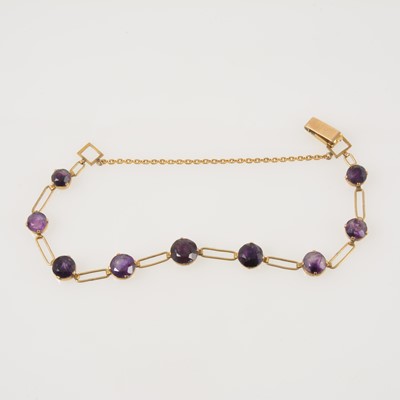 Lot 326 - A yellow metal bracelet individually claw set with nine amethysts