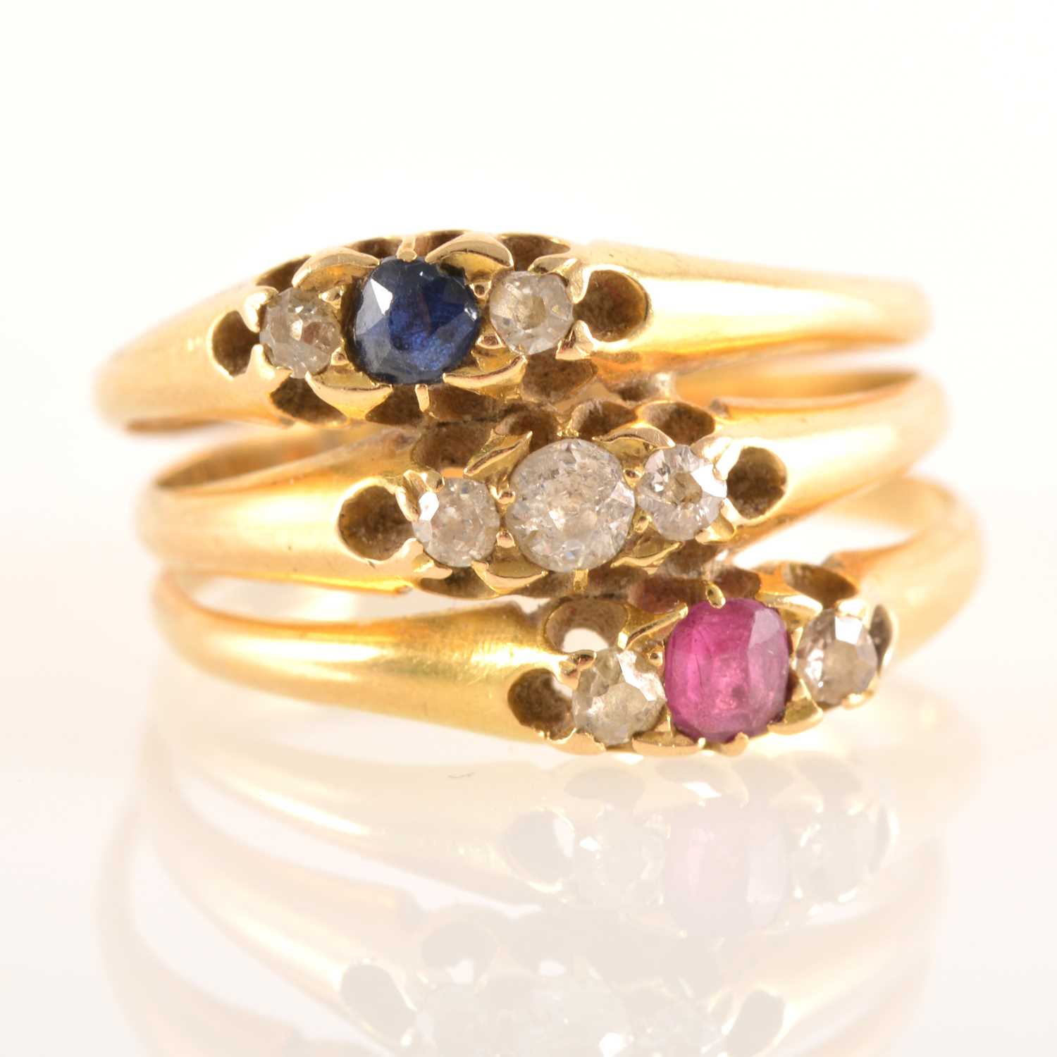 Lot 226 - Three joined dress rings, set with sapphires, diamonds and rubies.