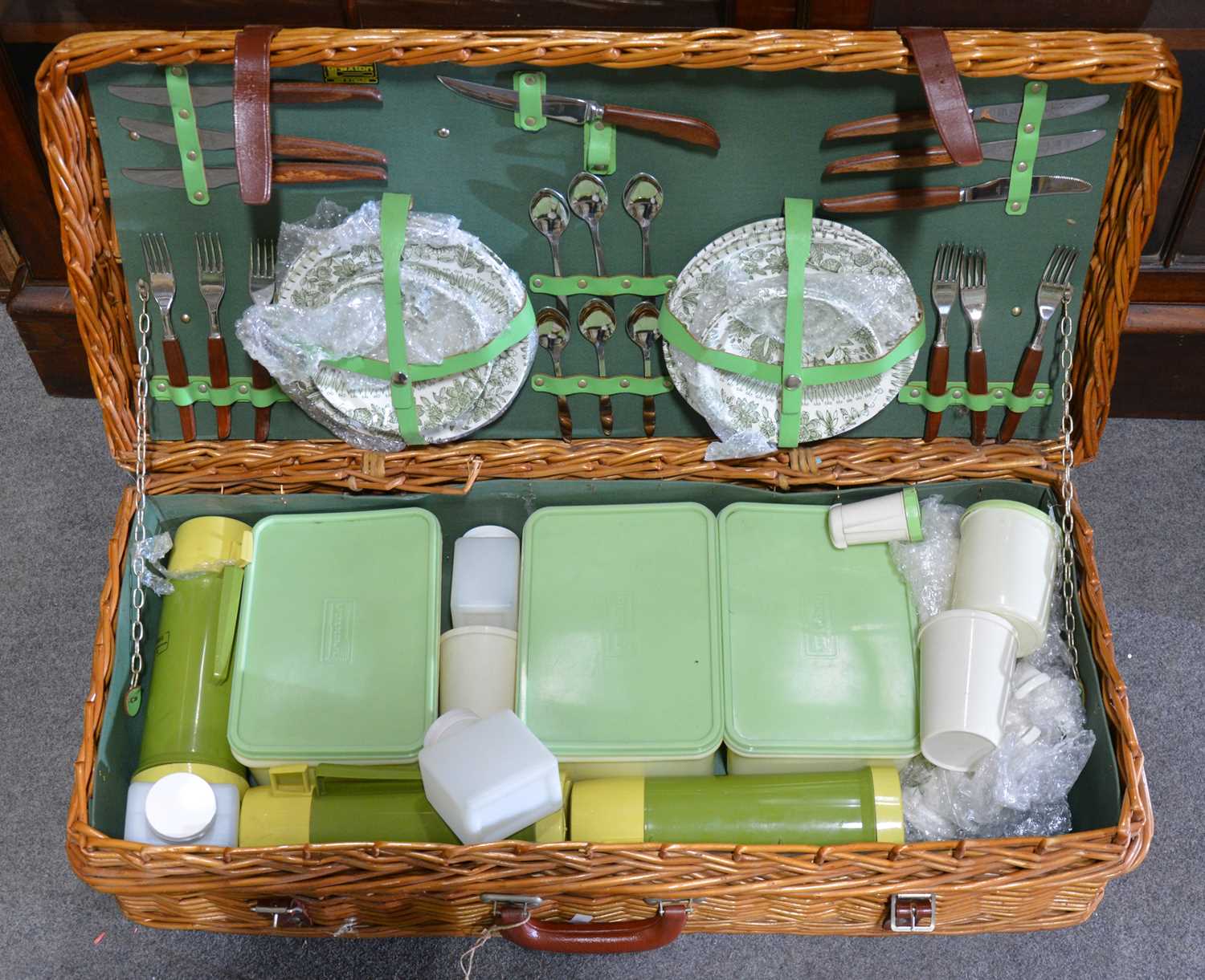 Lot 204 - A woven cane picnic hamper, fully fitted.