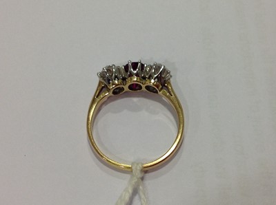 Lot 225 - A ruby and diamond three stone ring.
