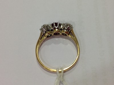 Lot 225 - A ruby and diamond three stone ring.