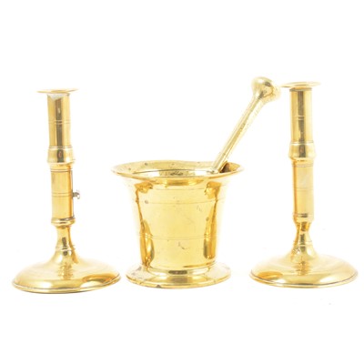 Lot 239 - Brass pestle and mortar and a brass candlesticks