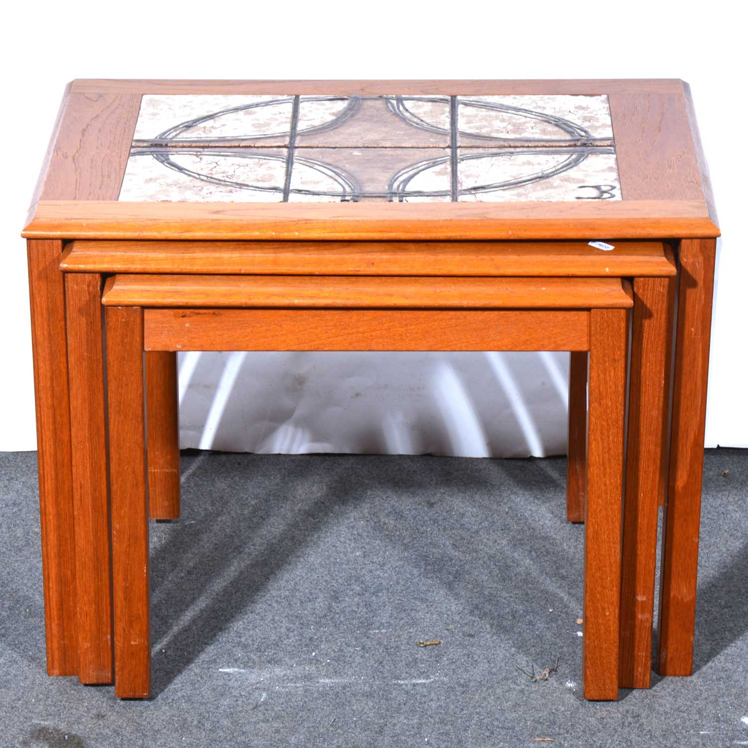 Lot 590 - Nest of three Danish teak coffee tables, with tile insets.