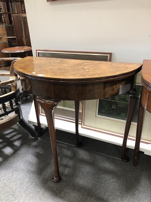 Lot 647 - A reproduction figured walnut demi-lune tea table