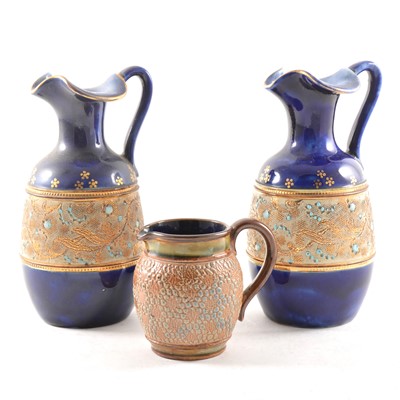 Lot 5 - A pair of blue ground Doulton & Slaters stoneware ewers, and another cream jug.