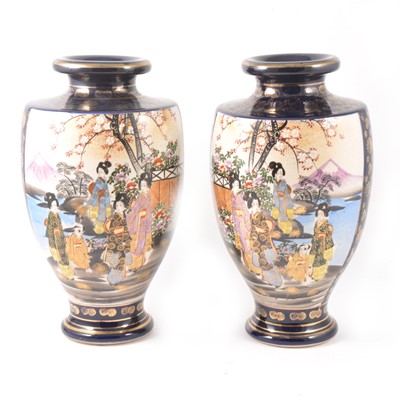 Lot 26 - A pair of Japanese Satsuma shouldered vases decorated with two panels of colourful figures in a garden.