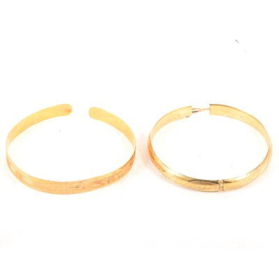 Lot 197 - Two yellow metal bangles - one marked 14K