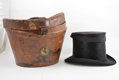 Lot 187 - Leather top hat box and a black silk top hat