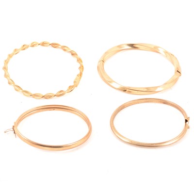 Lot 196 - Four modern gold bangles.