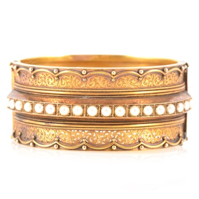 Lot 212 - A Victorian yellow metal half hinged bangle set with pearls.
