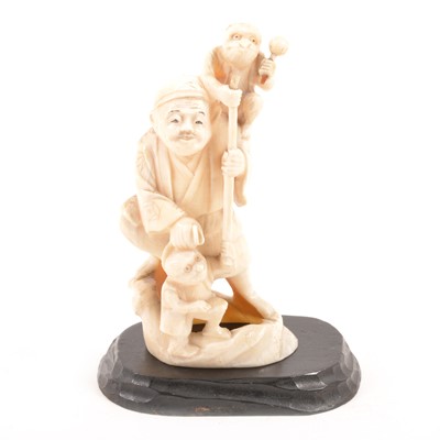 Lot 157 - An ivory okimono of an elderly gentleman with two monkeys and a staff.10cm