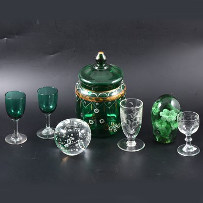 Lot 73 - A green glass paperweight and one other, two green stemmed glasses