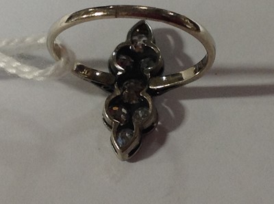 Lot 201 - An Art Deco seven stone diamond ring.