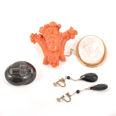 Lot 210 - A carved coral brooch, cameo brooch and jet brooch.