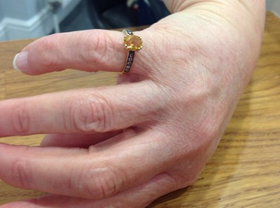Lot 209 - A citrine and chocolate diamond ring.