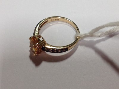 Lot 209 - A citrine and chocolate diamond ring.