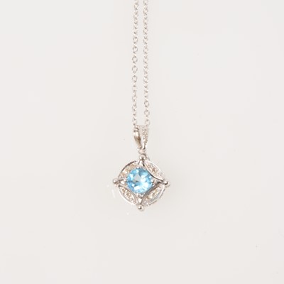 Lot 336 - A blue topaz and diamond pendant and chain.