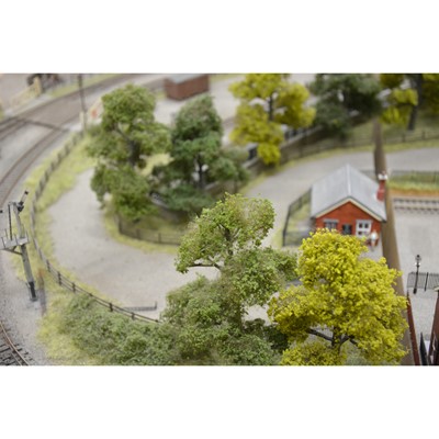 Lot 62 - Large railway layout; comes in four self containing wooden cases, with good landscaping of trees, buildings etc.