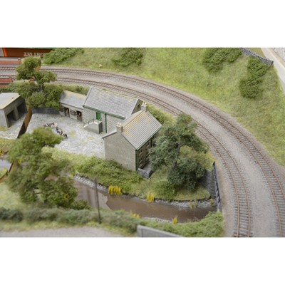 Lot 62 - Large railway layout; comes in four self containing wooden cases, with good landscaping of trees, buildings etc.