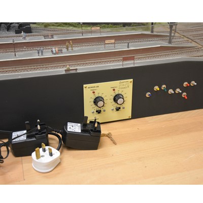 Lot 62 - Large railway layout; comes in four self containing wooden cases, with good landscaping of trees, buildings etc.