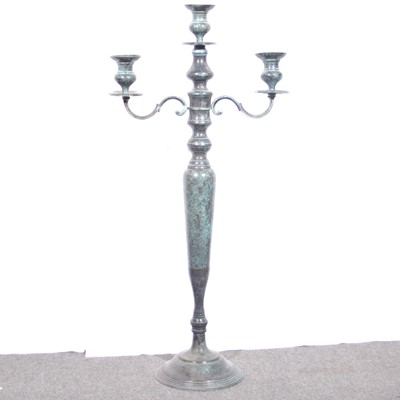 Lot 426 - A large patinated brass three-light candlestand.