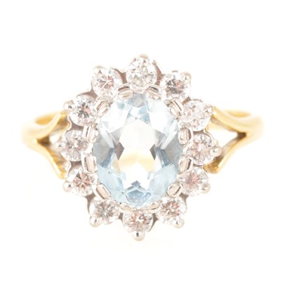 Lot 205 - An aquamarine and diamond oval cluster ring.