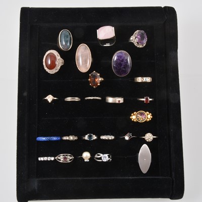 Lot 317 - Twenty-five dress rings set with various stones in a black velvet ring tray.