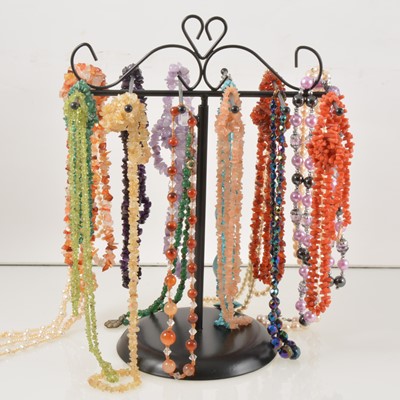 Lot 351 - A collection of tumblestone necklaces on a stand.