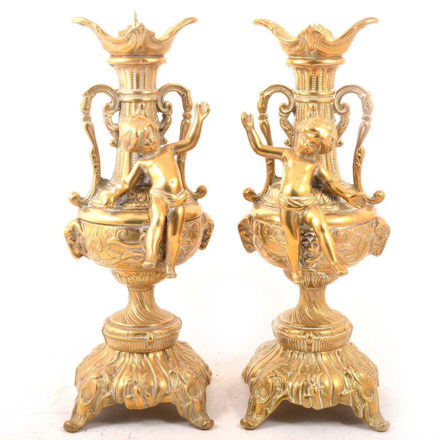 Lot 130 - A pair of brass pricket candlesticks with cherubs