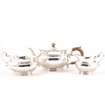 Lot 302 - A silver three piece teaset, London 1911, makers mark CCP, stylised fern leaf decoration to lower half of body