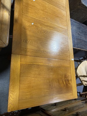 Lot 81 - An oak draw-leaf dining table.