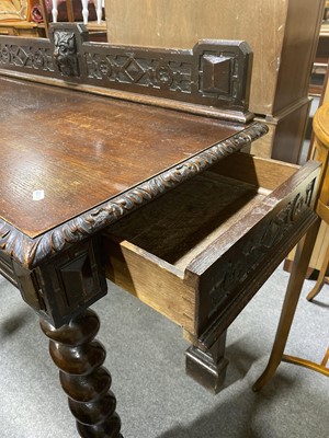 Lot 39 - A carved and stained oak hall table.