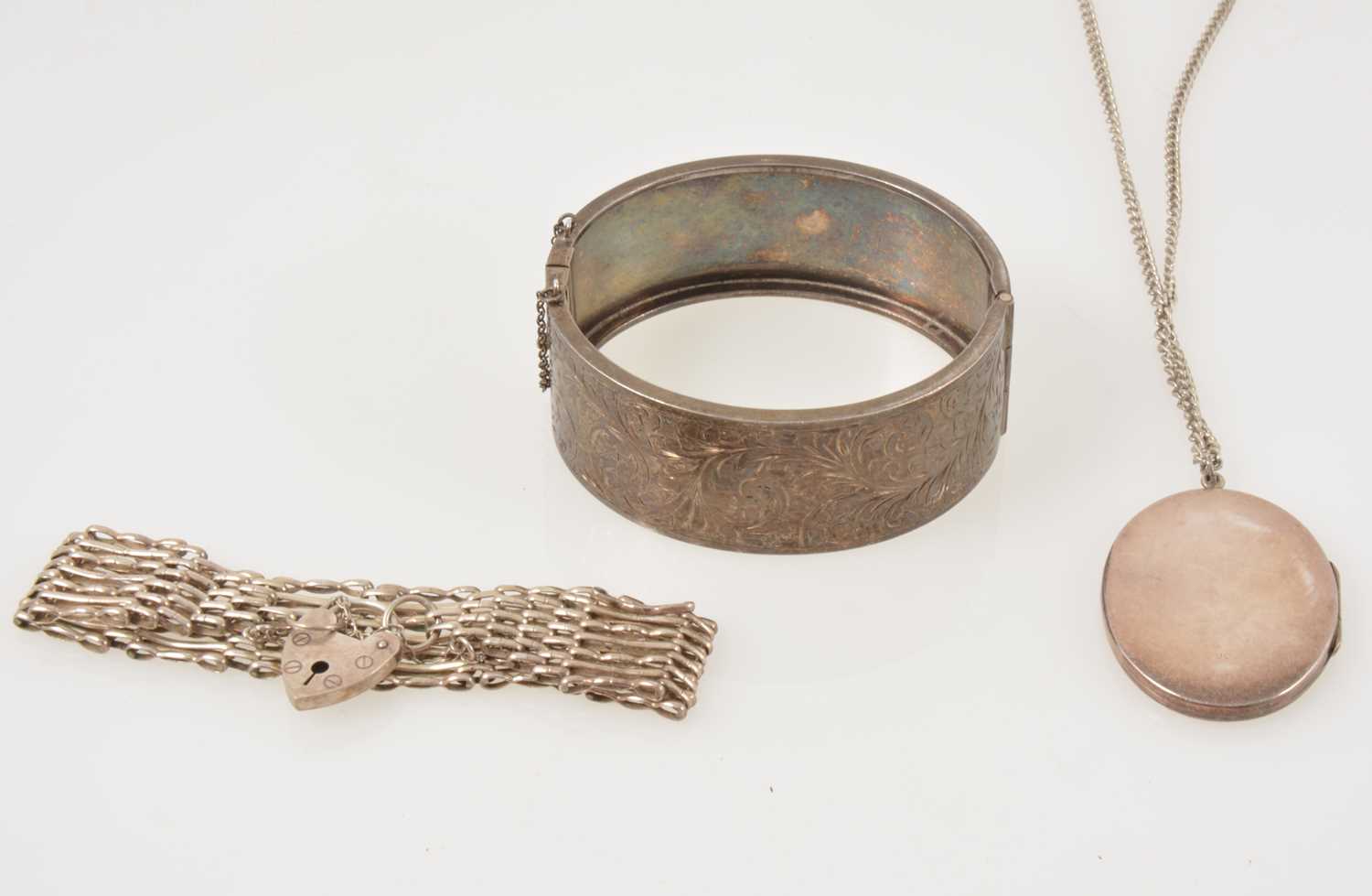 Lot 344 - A silver half hinged bangle, locket and