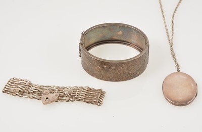 Lot 344 - A silver half hinged bangle, locket and chain and gate bracelet.