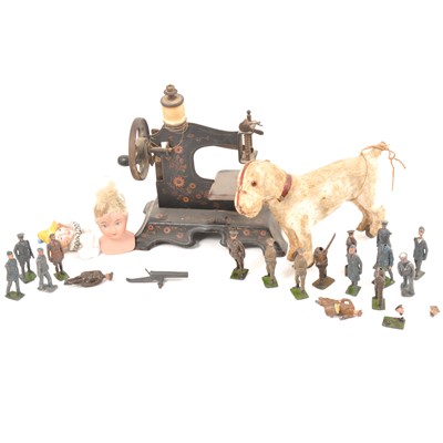 Lot 191 - A child's hand crank toy sewing machine, lead figures, dog on wheels, three dolls heads.