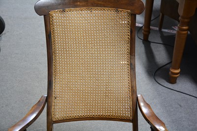 Lot 100 - A stained beech and cane bergere panelled steamer chair.