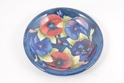 Lot 121 - A William Moorcroft 'Pansy' plate, circa 1928