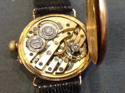 Lot 225 - An 18 carat yellow gold lady's half hunter wristwatch on a black leather strap