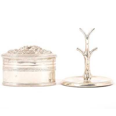 Lot 157 - A white metal oval trinket box and a silver ring holder.