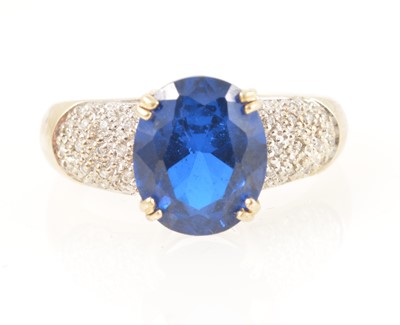 Lot 336 - An oval blue paste and diamond ring