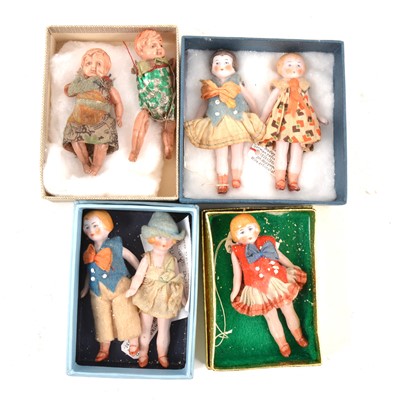 Lot 219 - Five miniature bisque dolls house dolls and two similar plastic dolls.