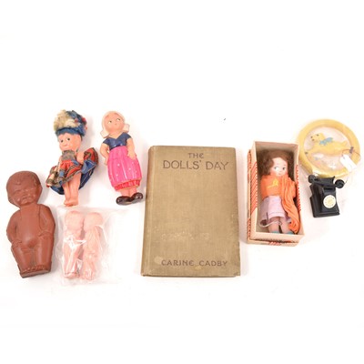 Lot 214 - A box of vintage toys, tin-plate aircraft carrier, crocodile, celluloid dolls, Spudmatic gun, jigsaws.