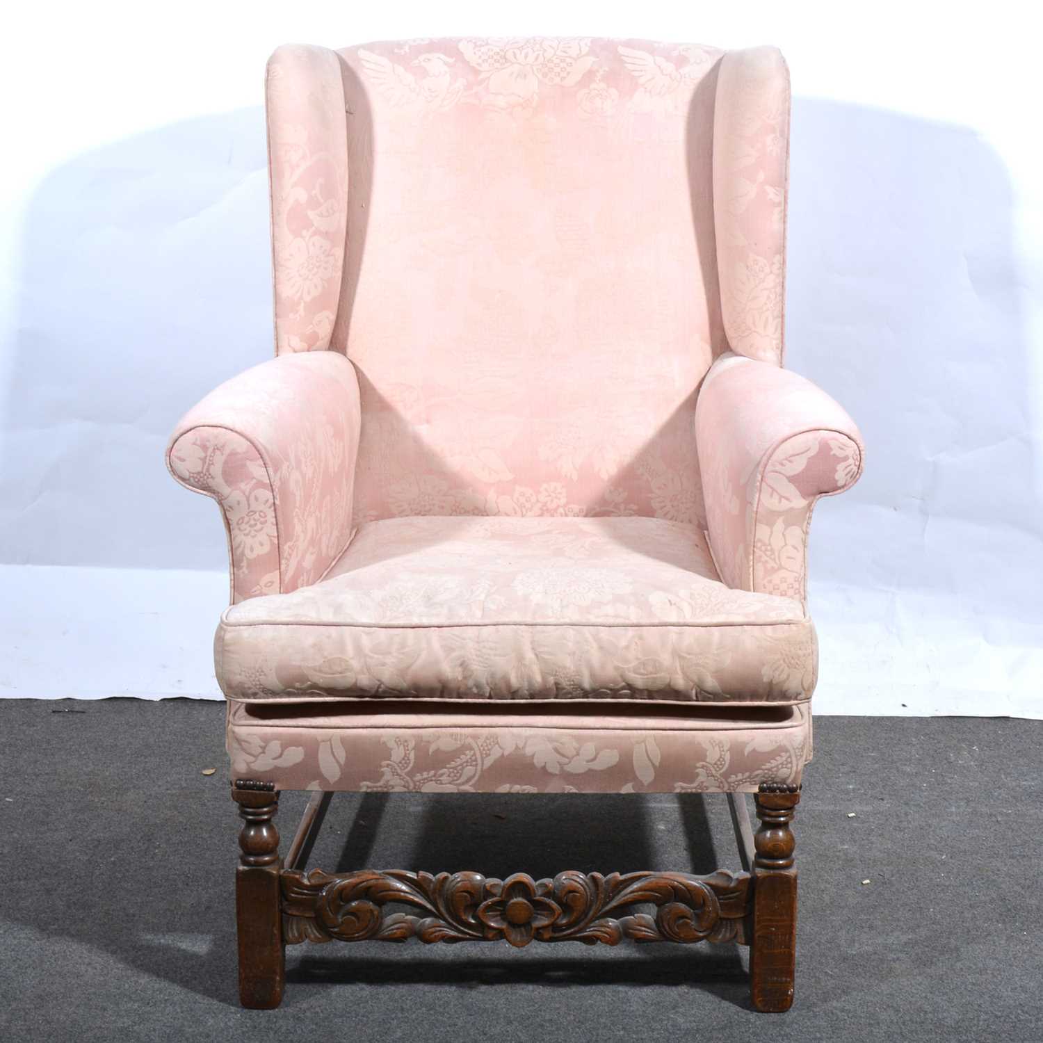 Lot 34 - A wing-back easy chair.