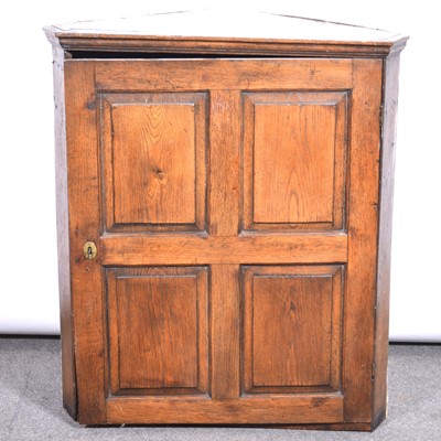 Lot 405 - An old oak corner cupboard