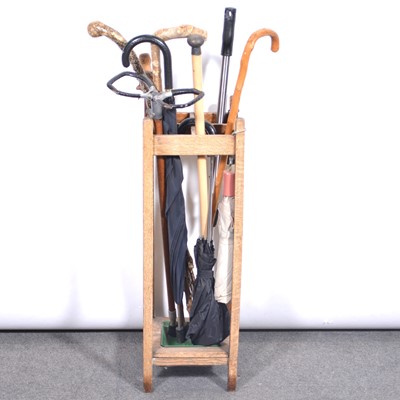 Lot 399 - Oak stick stand, and a collection of walking sticks.