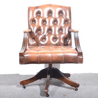 Lot 438 - A leather office elbow chair.